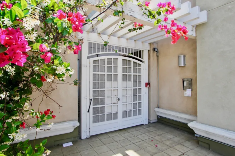 Flowers on a pergola near a front gate at Wilton Plaza in Koreatown