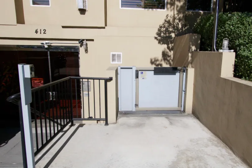 A wheelchair elevator to the right of the stairs at Wilton Villas
