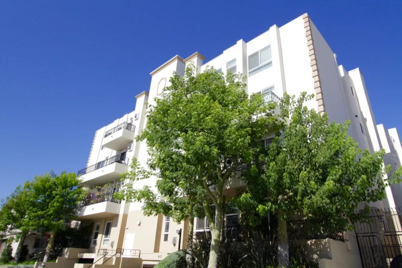 Large green trees stand at both ends of the Wilton Villas property