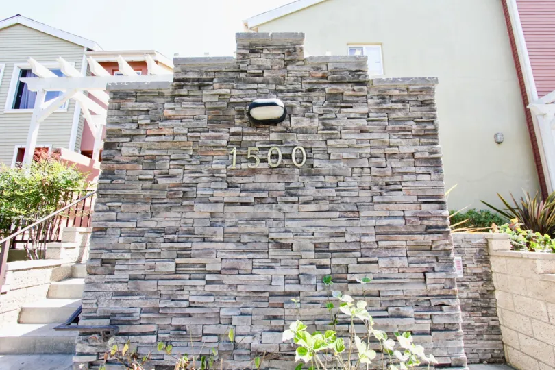 The address on the rock wall in front of 1500 Pine Ave in Long Beach, California