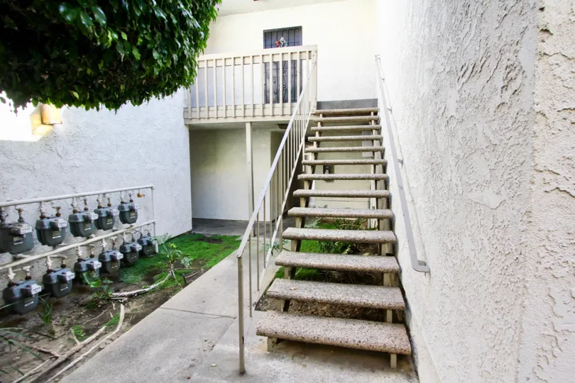 A unit door at the top of the stairs in Bixby Knolls