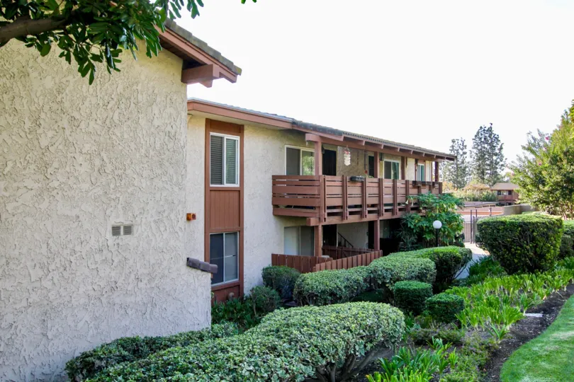 The hedges lining the Country Club Villas building