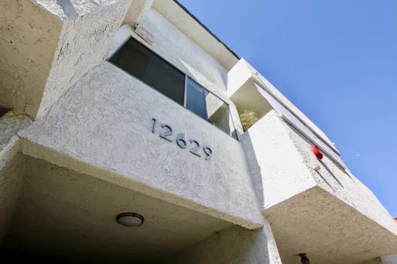 The address for 12629 Caswell Ave on the building