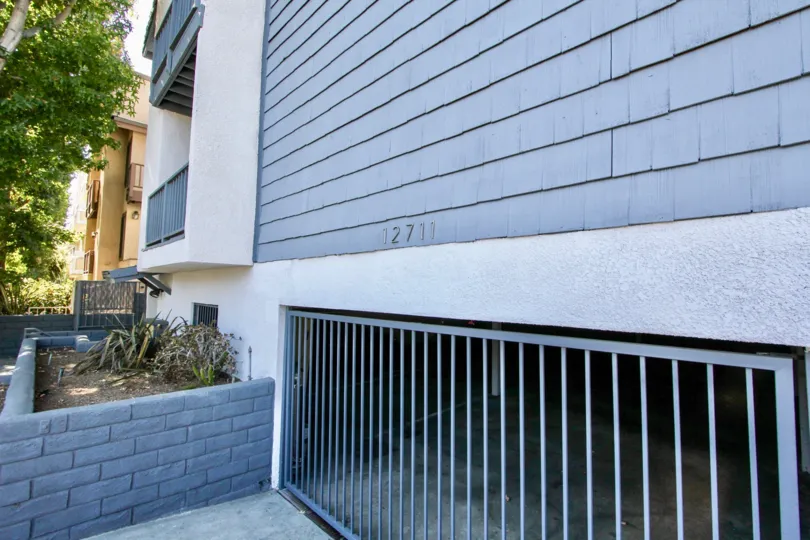The gate into the parking area for residents at 12711 Mitchell Ave