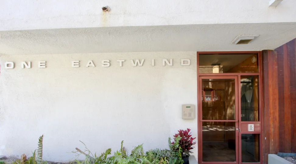 A view of 1 Eastwind, a building with a clean, modern streamlined look.