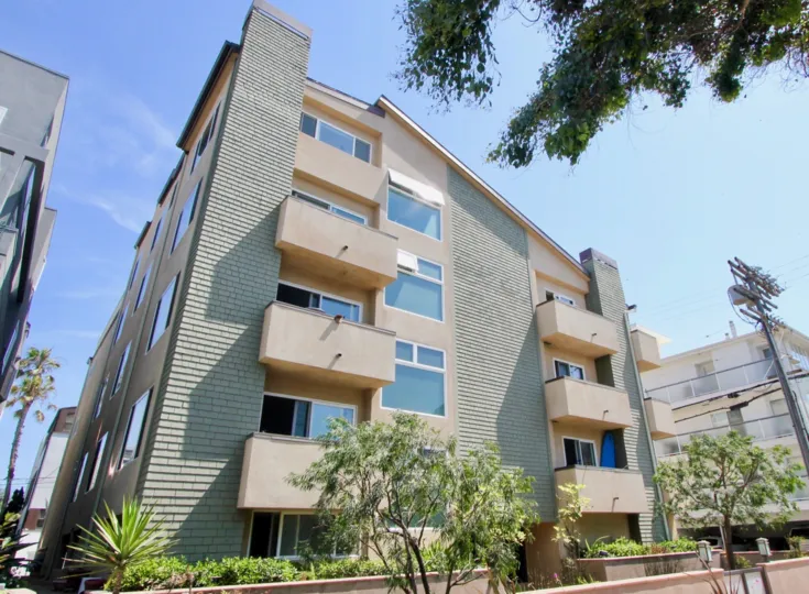 a brown building in 16 Quarterdeck in a sunny day