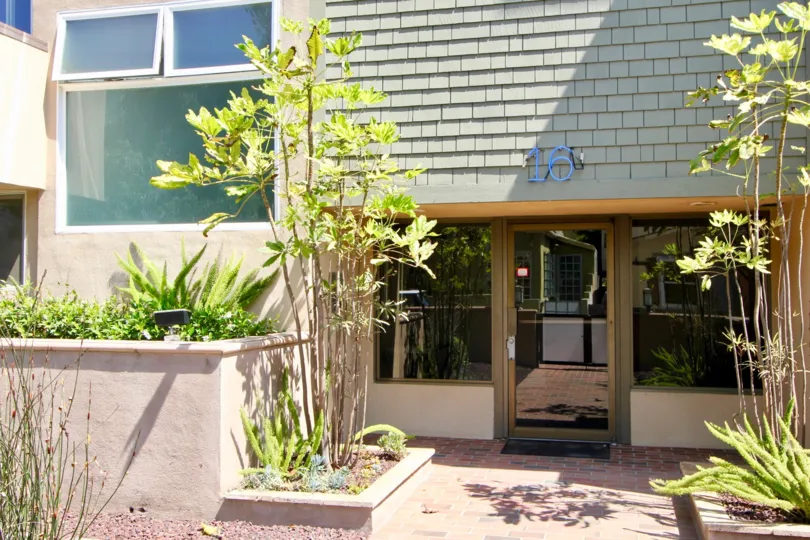 The door to 16 Quarterdeck in Marina del Rey California reflects the brick walkway and sunshine outside