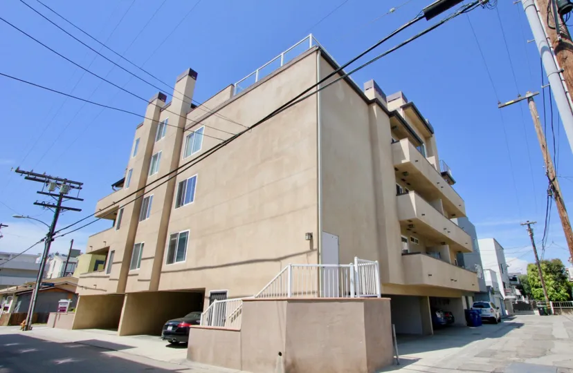 A lovely day on 16 Quarterdeck, a residential building with covered parking and a modern feel.