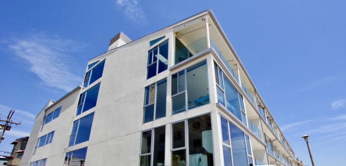 The 4 Jib building with many glass windows and a grey color