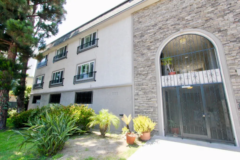 A lovely day at Cassa Del Rey, a residential building with an iron gated lobby.