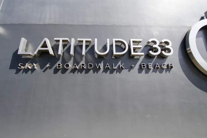 The name of Latitude 33 Beach Collection on the building