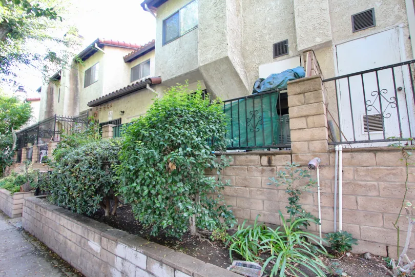 Stucko apartments with brick and iron architecture and nice landscaping