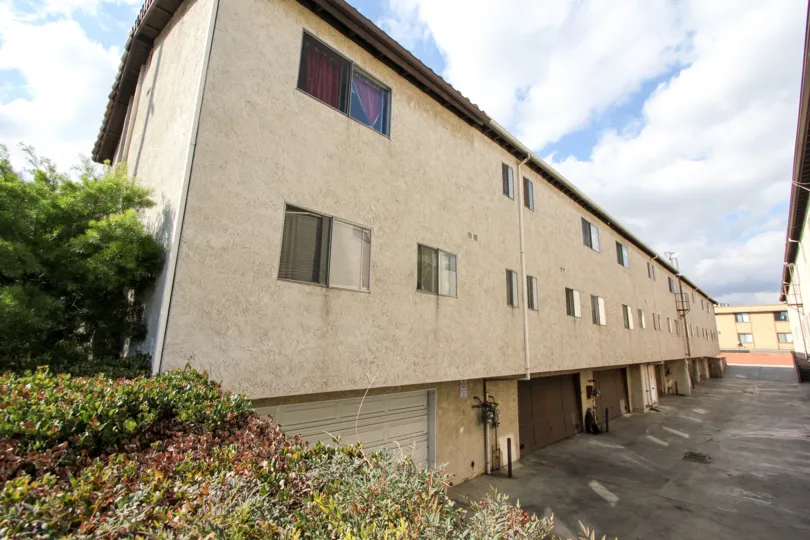 An off white stucco apartment building in Panorama City California during the day