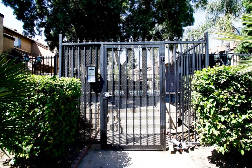 The gated entrance into Woodman Townhomes in Panorama City California