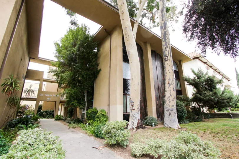 The sidewalk through the entrance of Los Robles South
