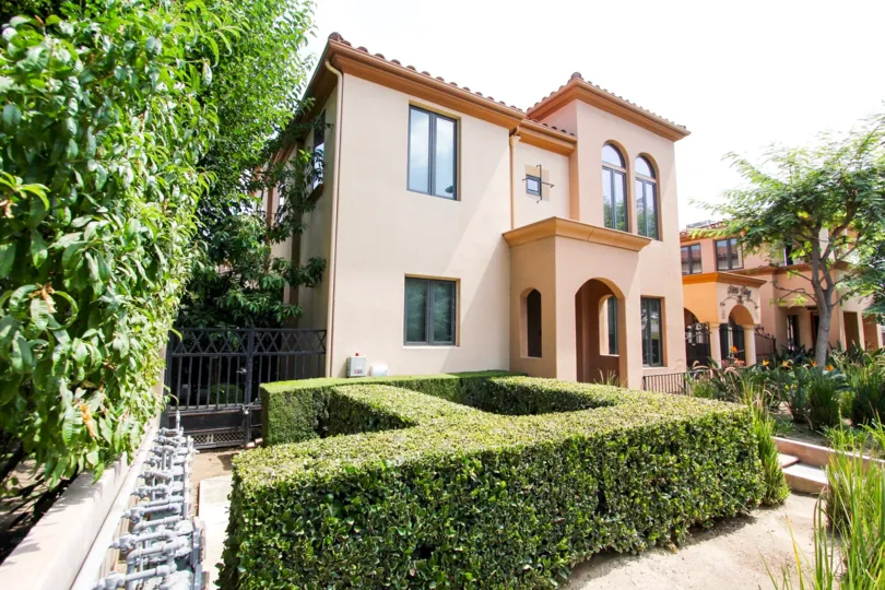 The intricate hedges around the Siena Village building