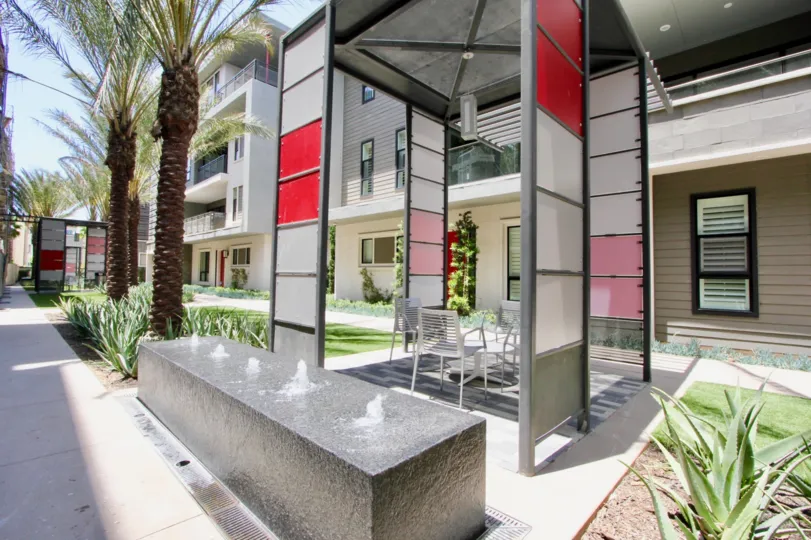 A sunny day in the Cleo with beautiful apartment and big tree infrond of apartment.