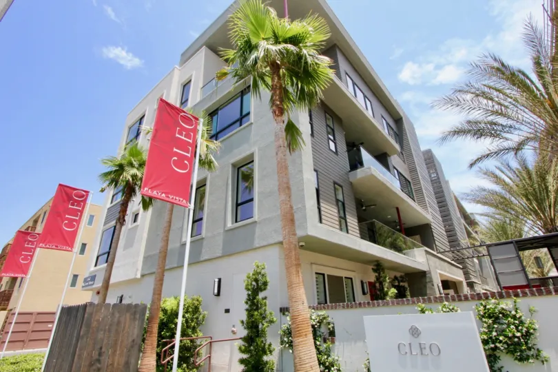 Amazing shot of cleo's entrance signage with red banners beside the beautiful green buildings, playa Vista California
