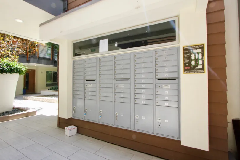 the mail lockers in primera terra of a building in a suny day