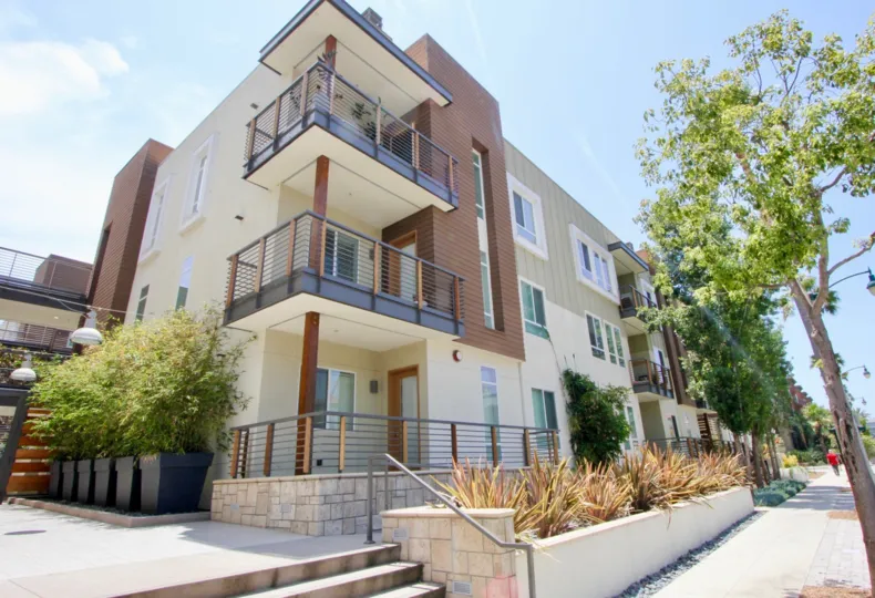 The sunny balconies along a sidewalk view of Primera Terra in Playa Vista.