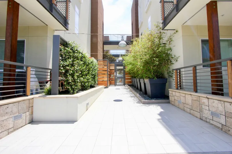 Apartments at Primera Terra, with lush trees and limestone bricks