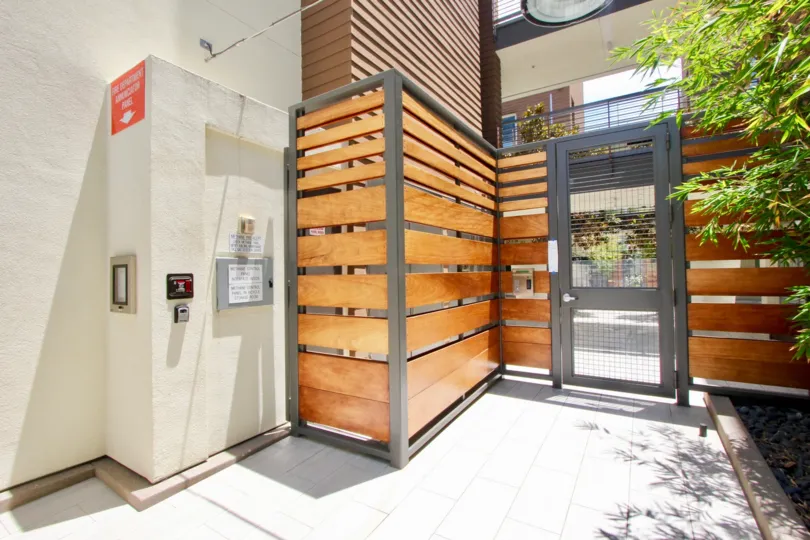 A modern and stylish security entrance gate with modern door and wood details