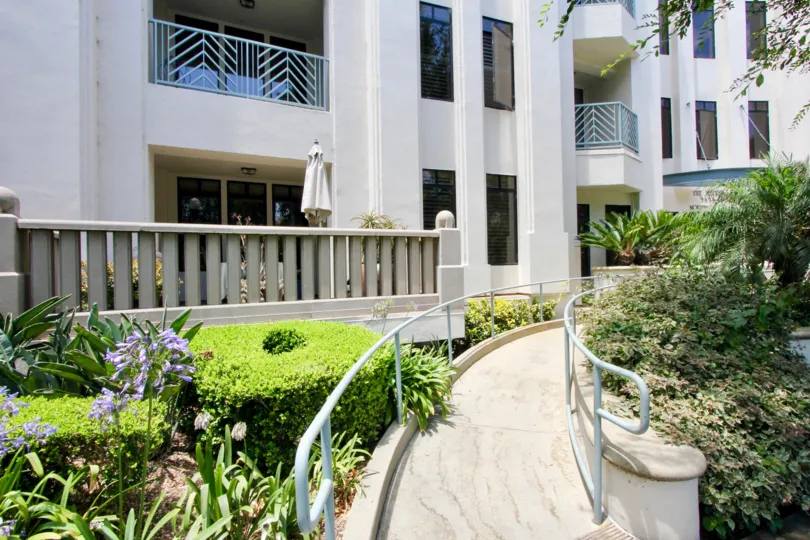 The Metro apartments with a wheelchair ramp and trees