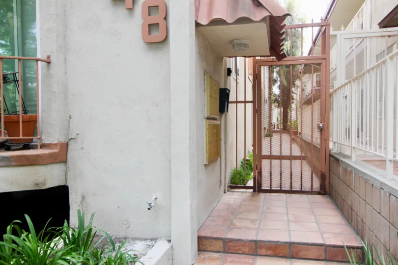 THIS HOUSE IS CLOSED IRON GATE HOUSE FRONT SIDE A SMALL GRASS GROWTH.
