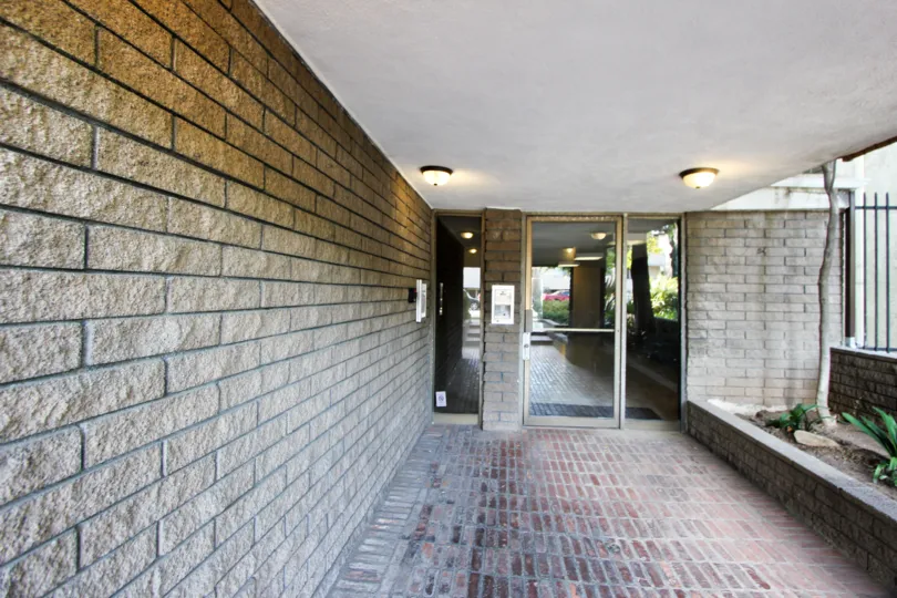 Large wall of stone in santa monica leading to a glass door