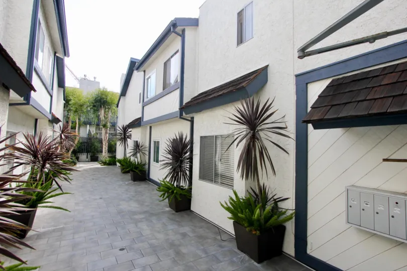 White buildings at 1218 9th St with black trim and brown roofing