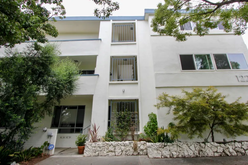 An apartment complex surrounded by beautiful trees.