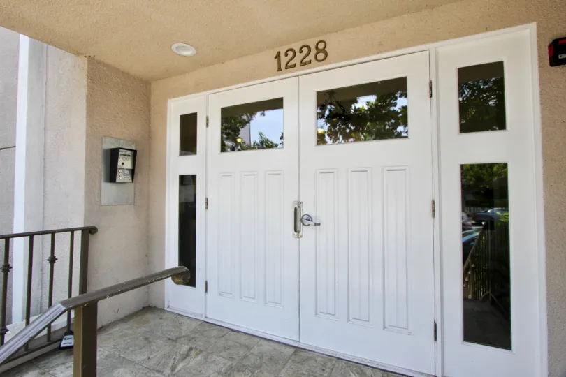A HOUSE OR ROOM WITH THE DOOR NUMBER 1228 AND LOOKS PEACEFUL WHITE COLOUR AT THE MORNING TIME