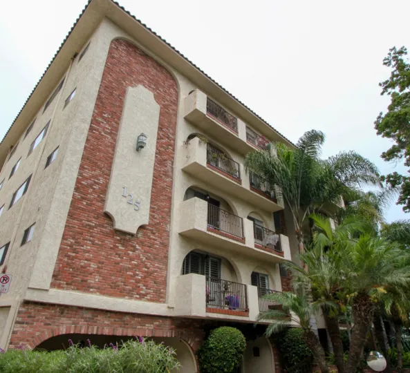 A big appartment in 125 Montana ave which seems to be it have four floors and the front side is filled with trees and plants