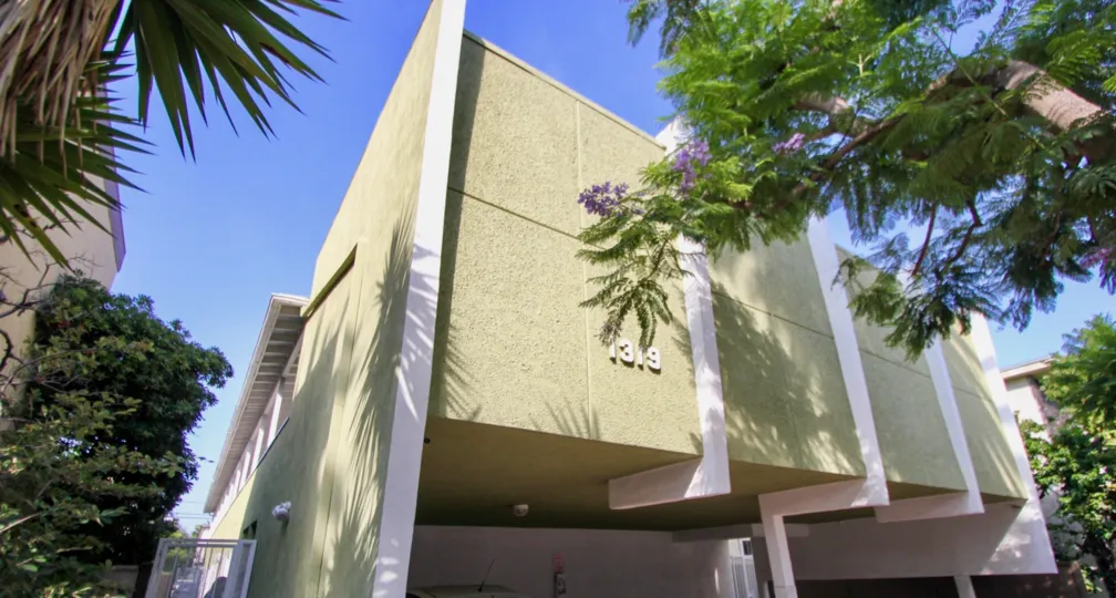 1319 11th St building with trees surrounding it on a sunny day.