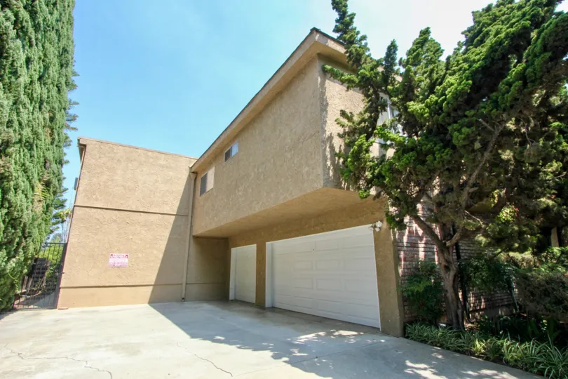 An empty driveway with closed garages in 3219 Colorado community.