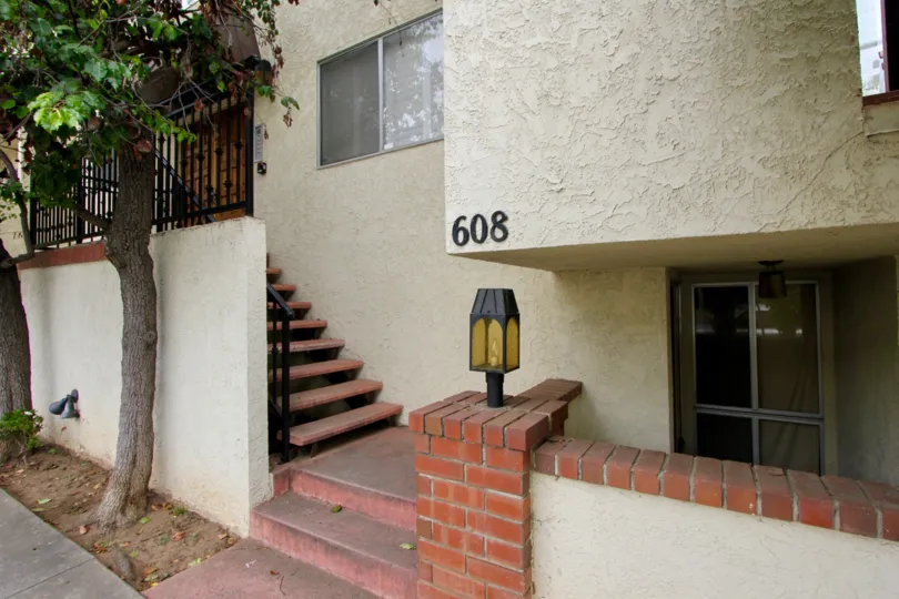 Entrance to 608 Idaho Ave with staircases and trees around it.