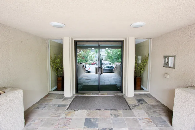 In sunny day the entrance is looking good and glass door is making good and attractive plants and lightings