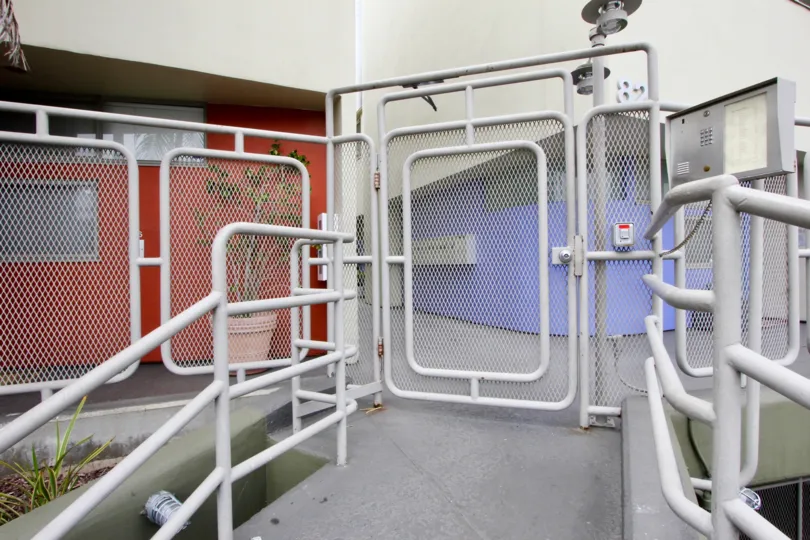 A screened gate in 821 Bay St. community rear entrance.