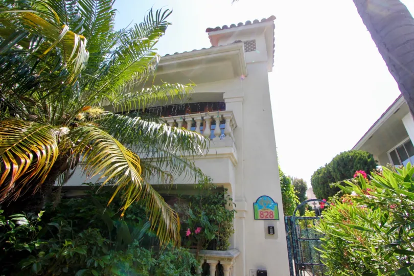 Sun shining bright over the 828 5th St villa surrounded by beautiful fauna