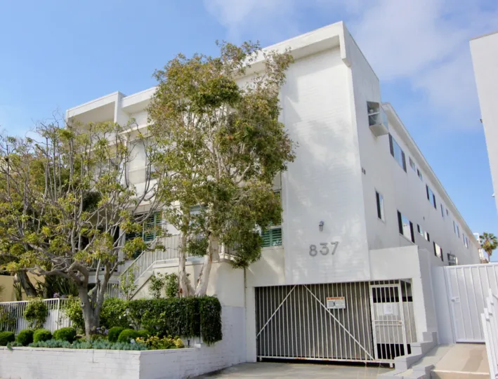 This 10th St community stands out against the blue skies and green trees