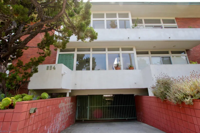 A SMALL GATE AND RED COLOUR BUILDING WITH TWO FLOORS WITH FULL OF GLASS WINDOWS LOOKS BEAUTIFUL TO SEE.