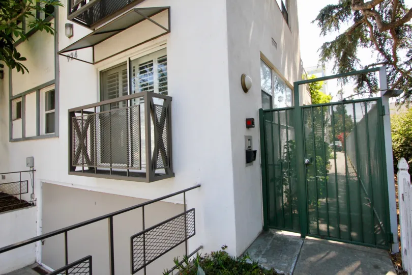 A sunny day in the 924 5th St with a green gate and balcony.