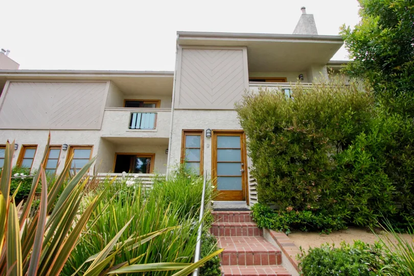 Red bricked house with two levels in the Bay Blue Vista Community.