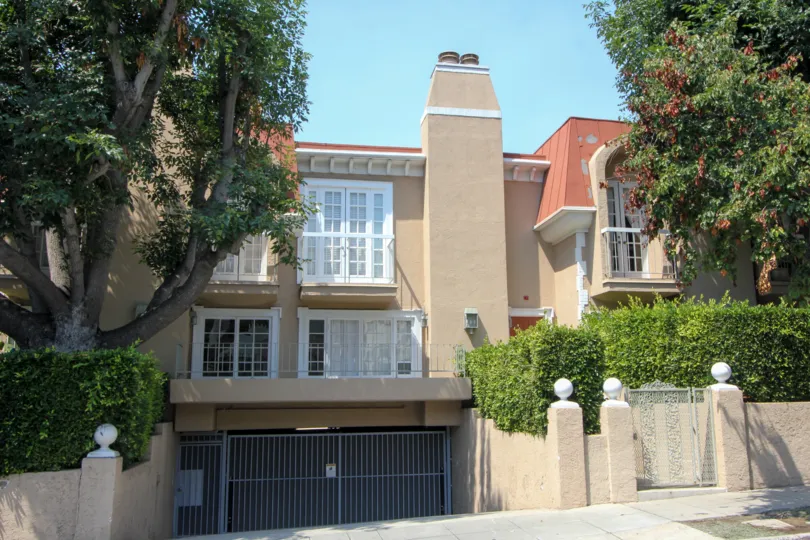 A clear day in the Berkeley Townhomes with trees and gate.