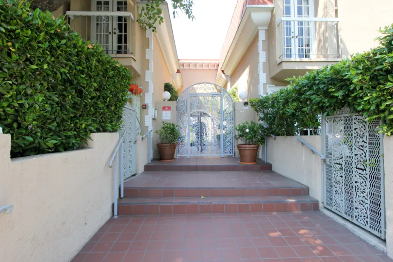 In a sunny day the house is looking good the painting is good and windows, doors and gates and made good condition green leafy plants and flowers