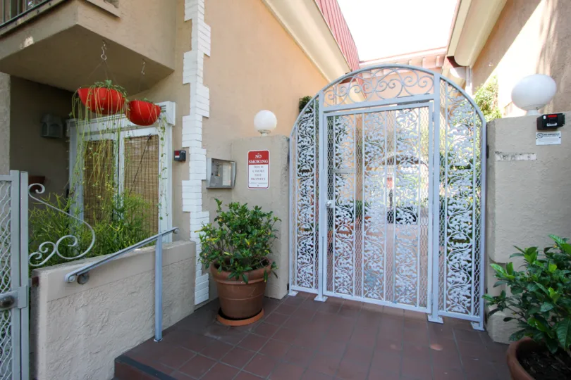 A sunny day the house is made good condition and design is good painting is good gate is excellant color