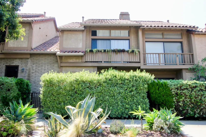 A two-storey housing with brick cladding and ceramic roof tiles in Berkeley Townhouse community.