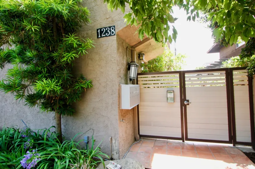 The home in the california1 has a very protective security gate and so many trees in front of the house so it looks very nice