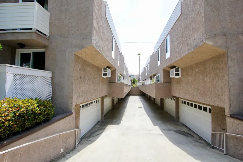 The roof is flat and is covered with red roof tiles. Two large chimneys sit at the side of the house. A few large windows let in just enough light to the rooms below the roof. The house itself is surrounded by a well kept garden. Grass, flower patches and