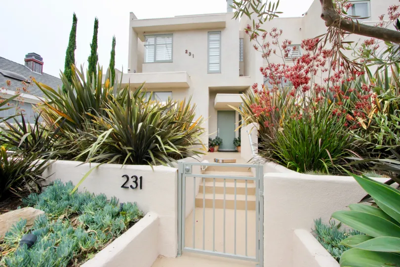 Big white building in santa monica with many windows and plants